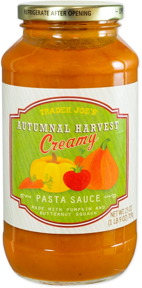A jar of Trader Joe’s Autumnal Harvest Creamy Pasta Sauce, featuring pumpkin and butternut squash illustrations on the label. The sauce is orange and the jar holds 25 ounces.