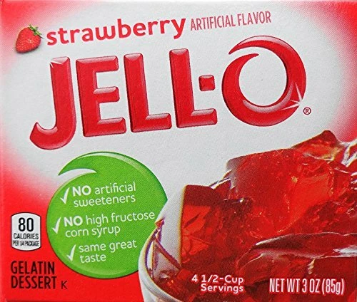 A box of strawberry-flavored Jell-O gelatin dessert, showing red Jell-O cubes in a bowl. The box highlights no artificial sweeteners, no high fructose corn syrup, and 80 calories per serving.