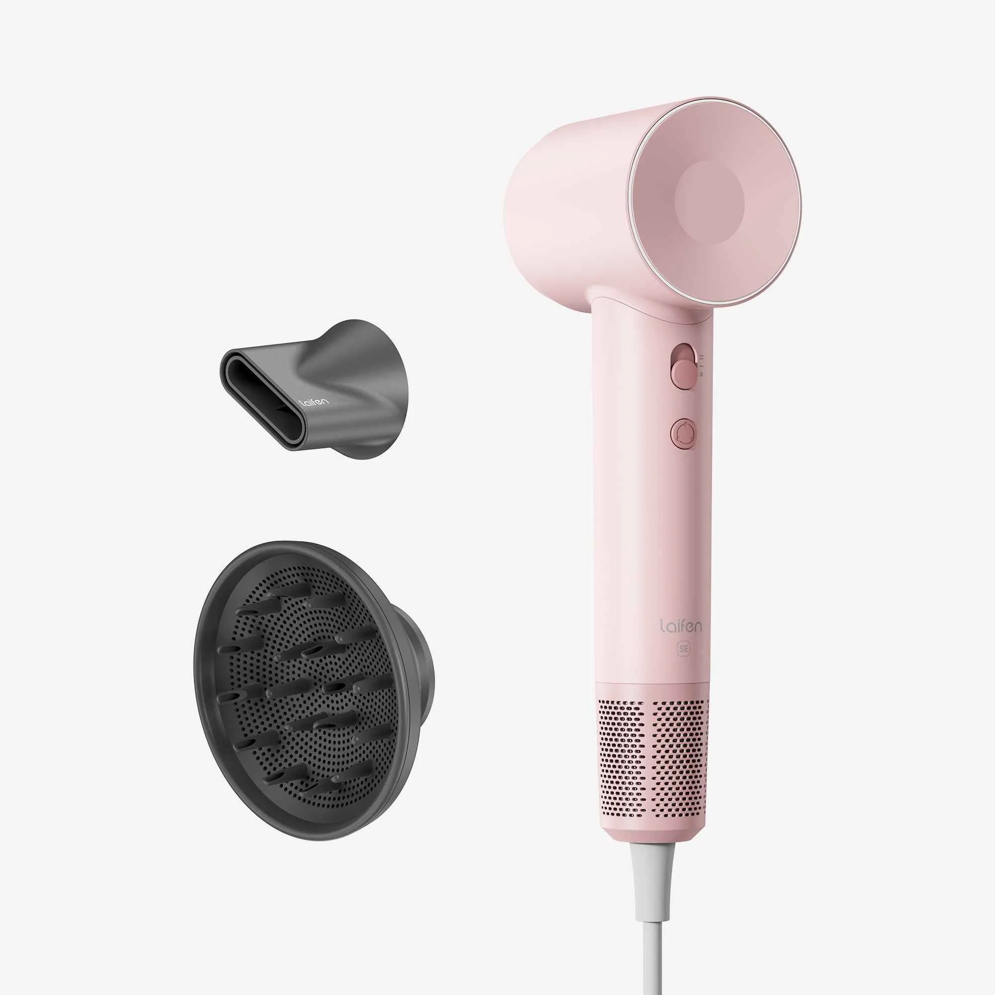 A pink hair dryer is shown with two black attachments—one concentrator nozzle and one diffuser—against a white background.