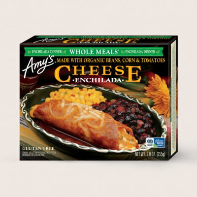 Box of Amy’s Cheese Enchilada frozen meal, featuring an image of an enchilada with cheese, corn, and black beans. Packaging highlights that it’s gluten free and made with organic ingredients.