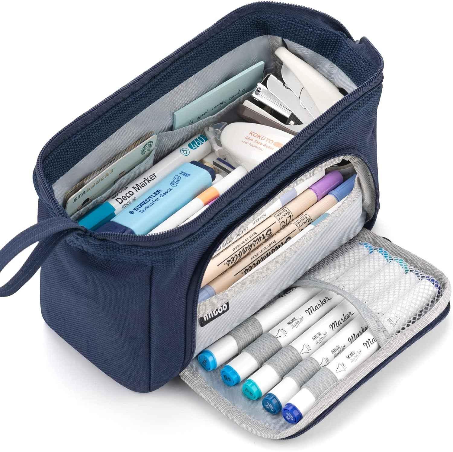 A navy blue pencil case unzipped to reveal organized stationery items, including pens, markers, a stapler, correction tape, and erasers neatly stored in compartments and mesh pockets.
