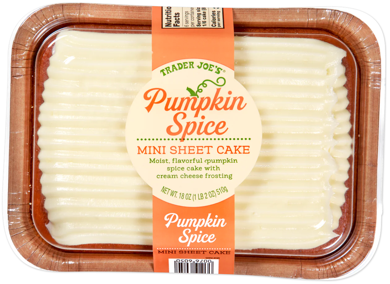 A Trader Joe’s Pumpkin Spice Mini Sheet Cake in a clear plastic container, topped with cream cheese frosting, with a round label describing the cake flavor and ingredients.