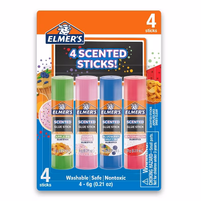 Four Elmer’s scented glue sticks in apple pie, sugar cookie, blueberry muffin, and watermelon scents in colorful packaging labeled “4 Scented Sticks!”