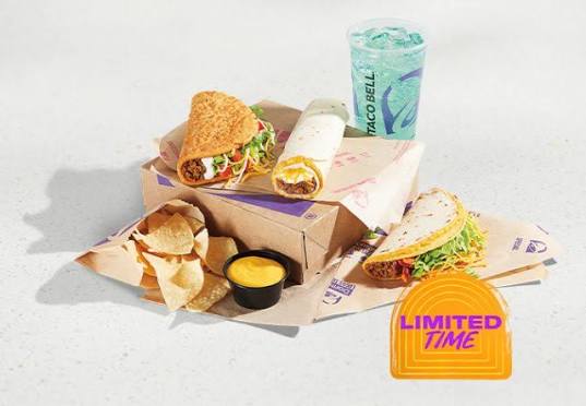 Taco Bell meal with chips and cheese, a hard shell taco, a soft taco, a burrito, and a blue drink. “Limited Time” is displayed in the bottom right corner.