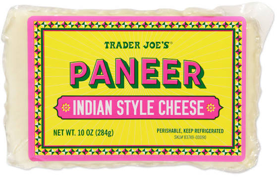 A package of Trader Joe’s Paneer Indian Style Cheese, 10 oz, with colorful yellow, pink, and green label. The cheese is rectangular, vacuum-sealed, and labeled as perishable and to be kept refrigerated.