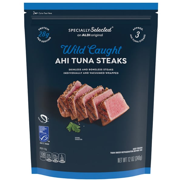 A blue bag of Specially Selected Wild Caught Ahi Tuna Steaks, featuring sliced tuna pieces and parsley. The packaging highlights 28g protein per serving and contains 12 oz (340g) of skinless, boneless tuna steaks.