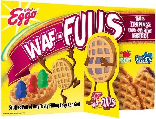 Eggo Waf-Fulls cereal box with large text, a waffle character holding a box, and images of fruit toppings. Flavors mentioned: cinnamon and blueberry. Text states toppings are on the inside.