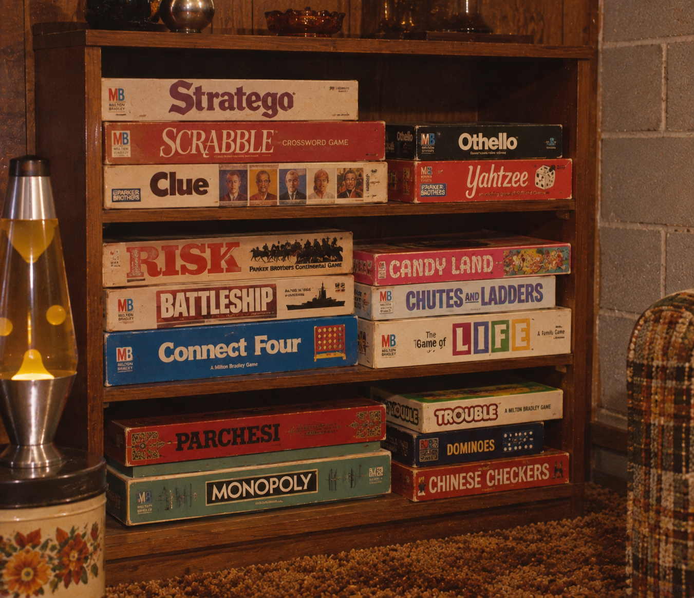 A wooden shelf holds classic board games like Scrabble, Clue, Monopoly, Battleship, Risk, and The Game of Life, with a lava lamp on the side and part of a plaid couch visible.