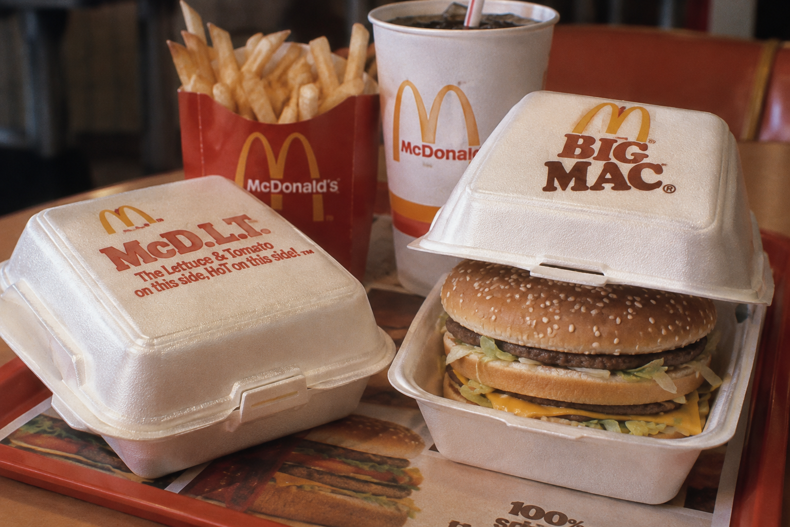 A McDonald’s meal with fries, a drink, a closed McD.L.T. box, and an open Big Mac box showing a burger, all on a tray.