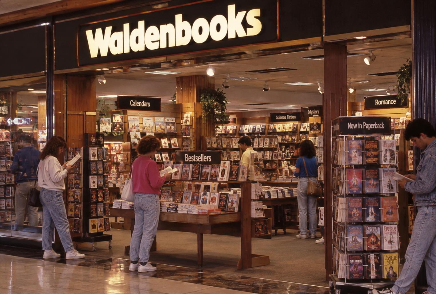People browse books at a Waldenbooks store in a mall. Signs for categories like Romance, Science Fiction, Calendars, and Bestsellers are visible, along with several display racks filled with books.