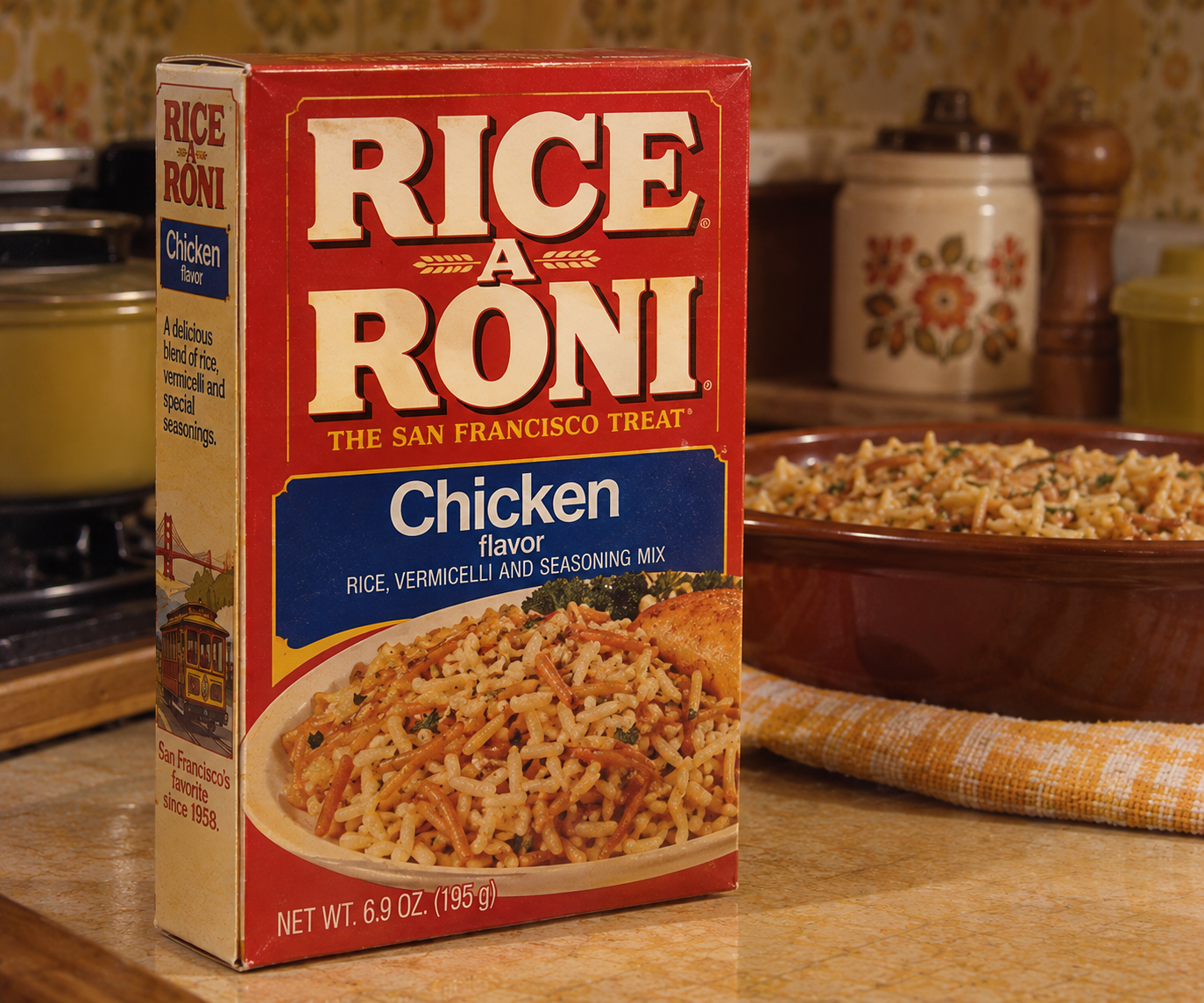 A box of Rice-A-Roni Chicken flavor sits on a kitchen counter next to a prepared dish of the product. There are pots and kitchenware in the background.