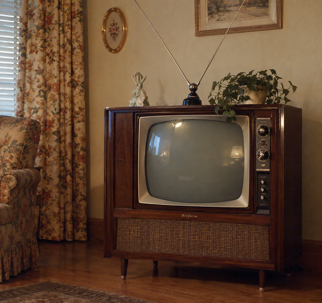 A vintage television with antenna sits in a cozy living room, next to floral curtains and an armchair, with a plant and figurine on top of the TV.