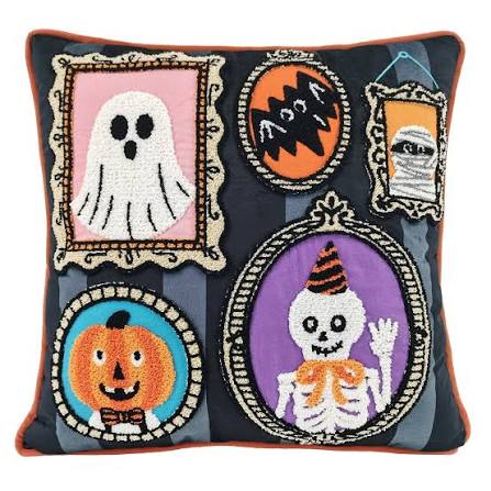 A square pillow decorated with framed Halloween-themed images, including a ghost, bat, mummy, pumpkin, and waving skeleton in a party hat.