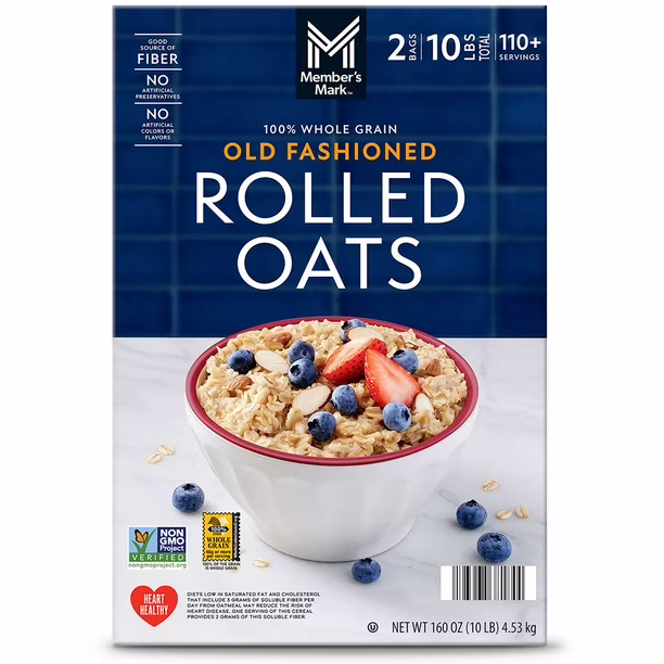 A box of Member’s Mark Old Fashioned Rolled Oats with a bowl of oatmeal topped with blueberries and strawberries on the front. The box highlights 10 lbs, non-GMO, whole grain, and 110+ servings.