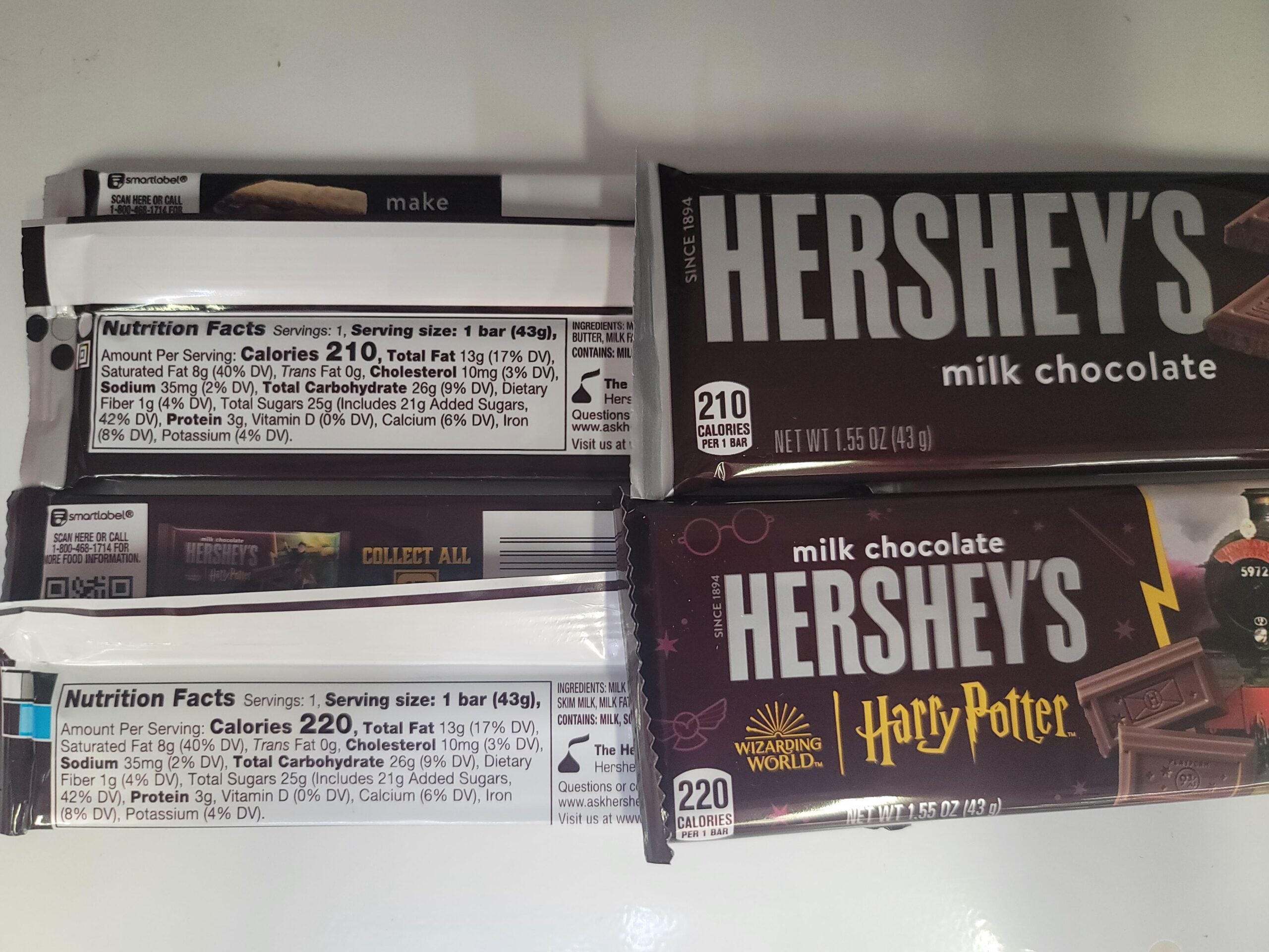 Two Hershey’s milk chocolate bars, one with a Harry Potter design, are shown with their nutrition facts visible. Both packages list calories per serving and other nutrition details.