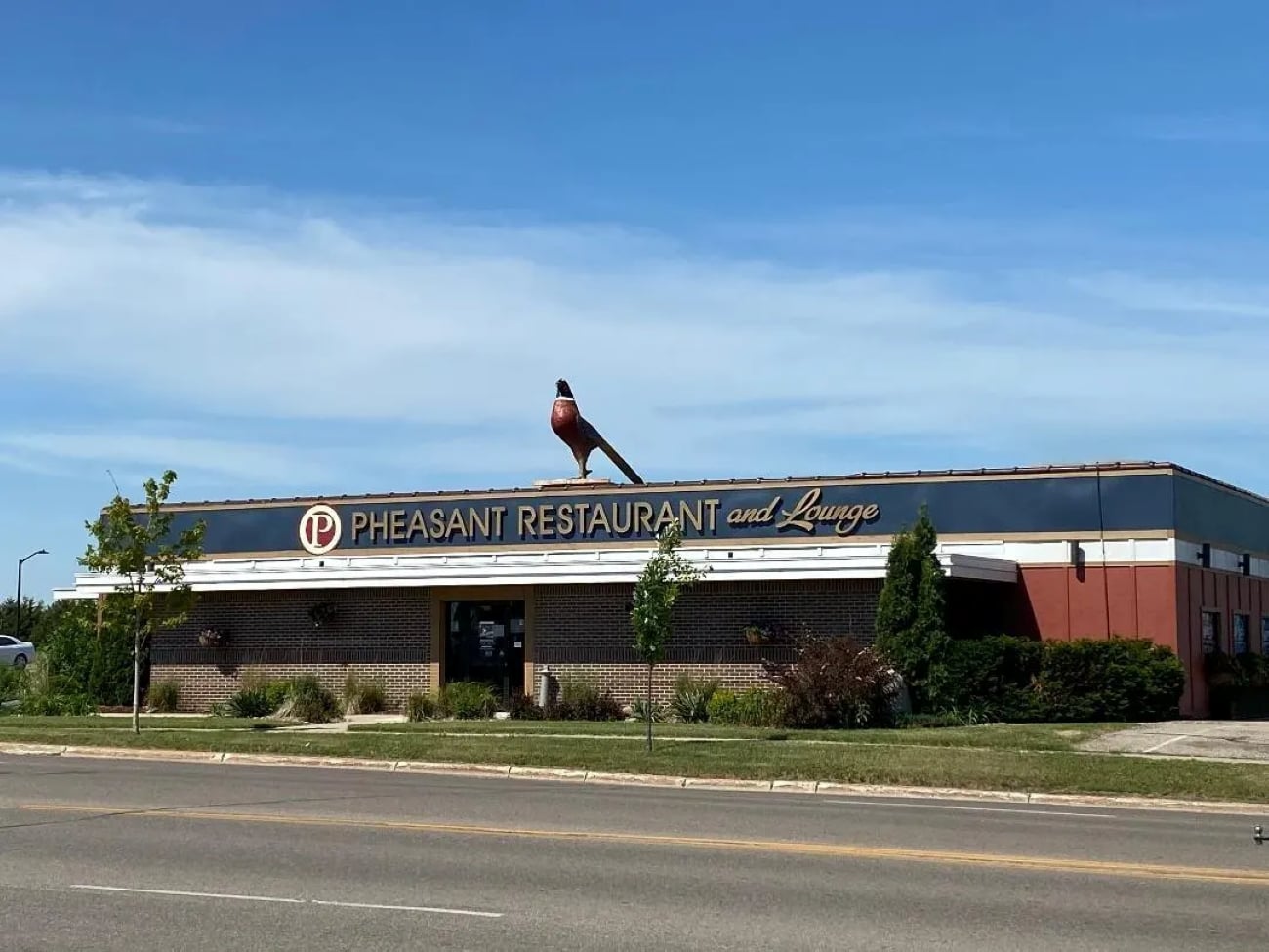 The Pheasant Restaurant and Lounge building with a large pheasant statue on the roof.