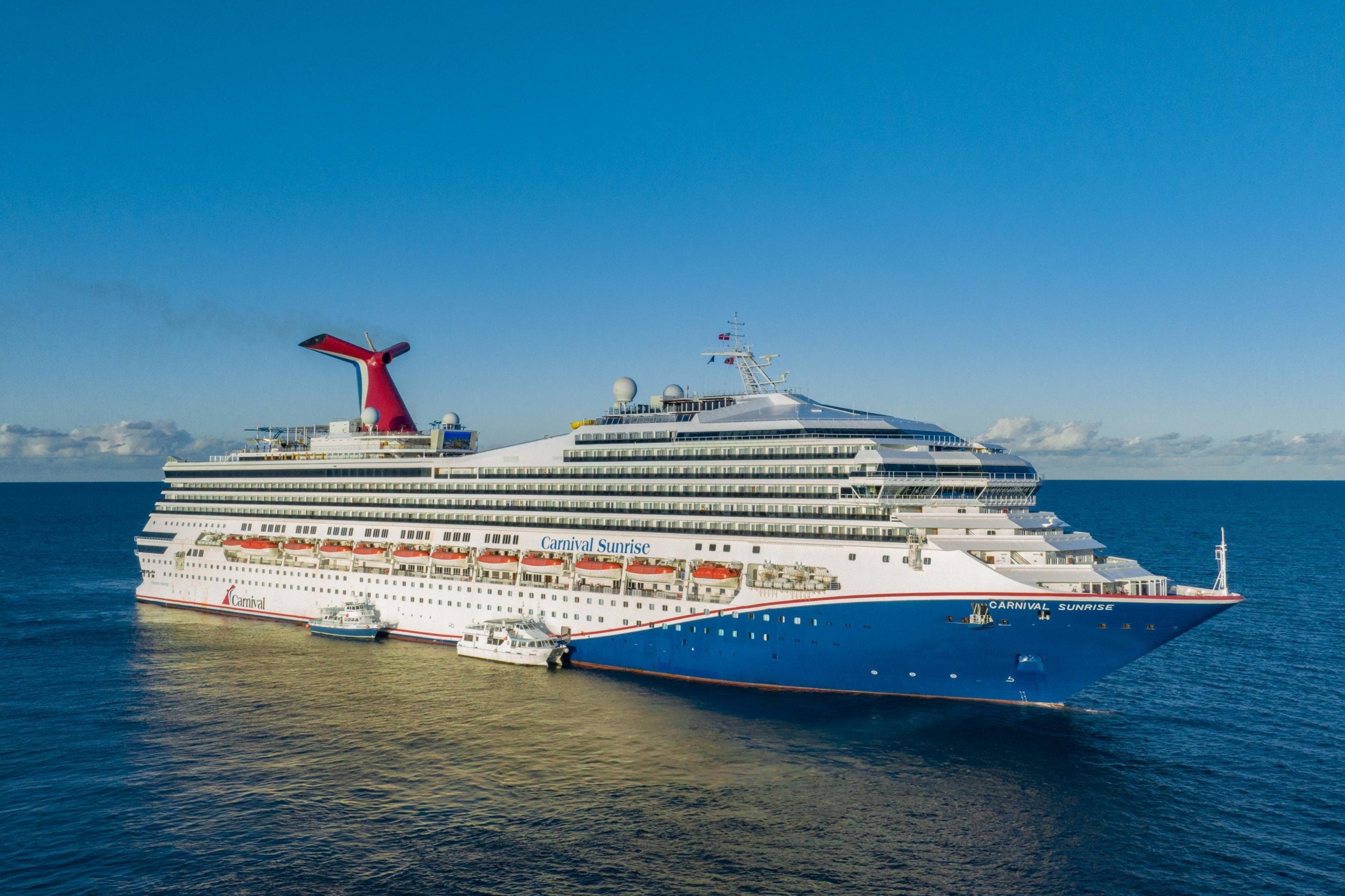 The Carnival Sunrise cruise ship sailing on the open ocean, where guests can enjoy cruise ship buffets.