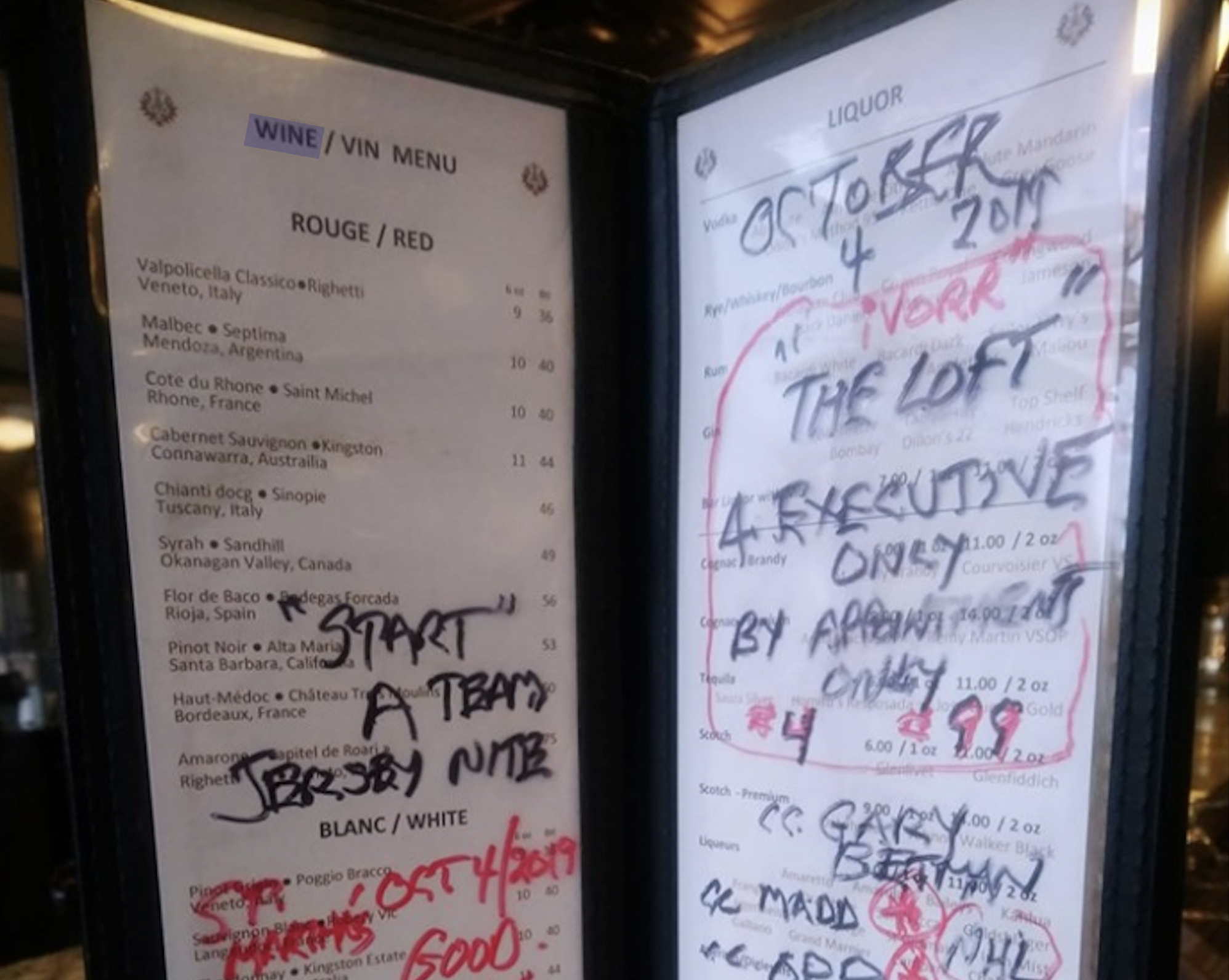 A wine menu with red and white wines on the left, and a marked-up liquor menu on the right with handwritten notes, dates, and phrases like “EXECUTIVE ONLY” and “BY APPOINTMENT ONLY.”