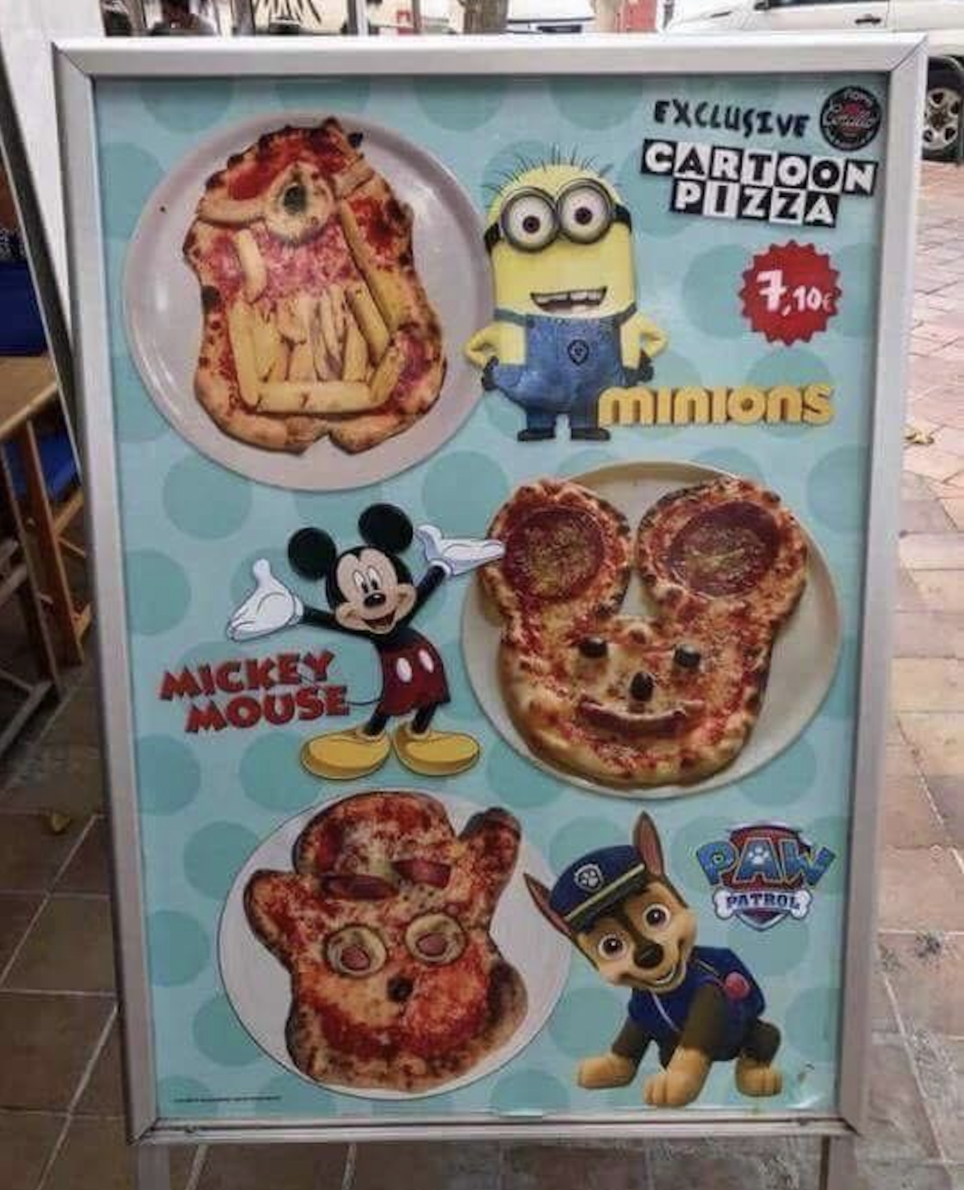 A sign advertising cartoon-shaped pizzas featuring Minions, Mickey Mouse, and PAW Patrol characters, priced at 7,10€.