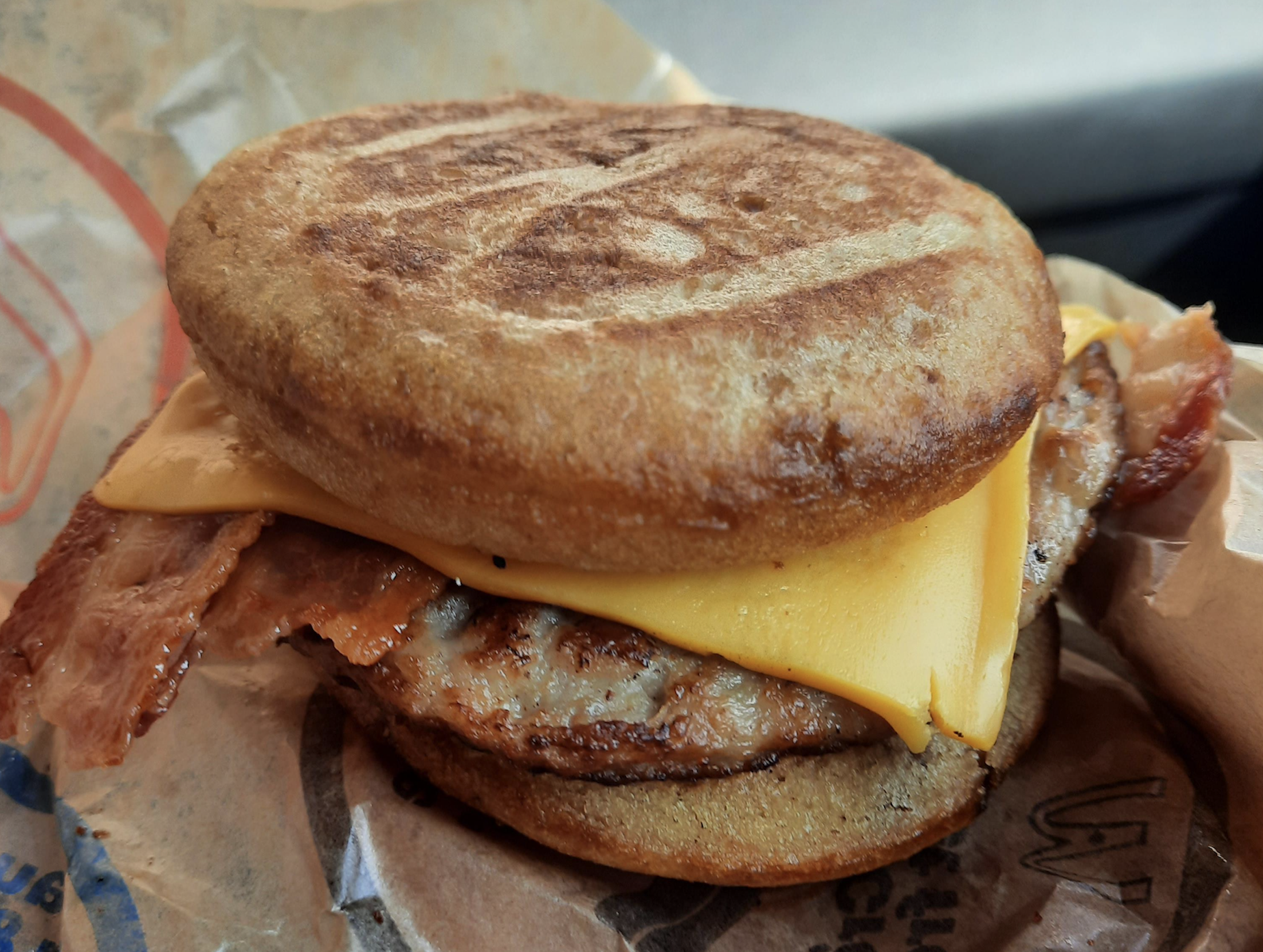A bacon, egg, and cheese breakfast sandwich on an English muffin.