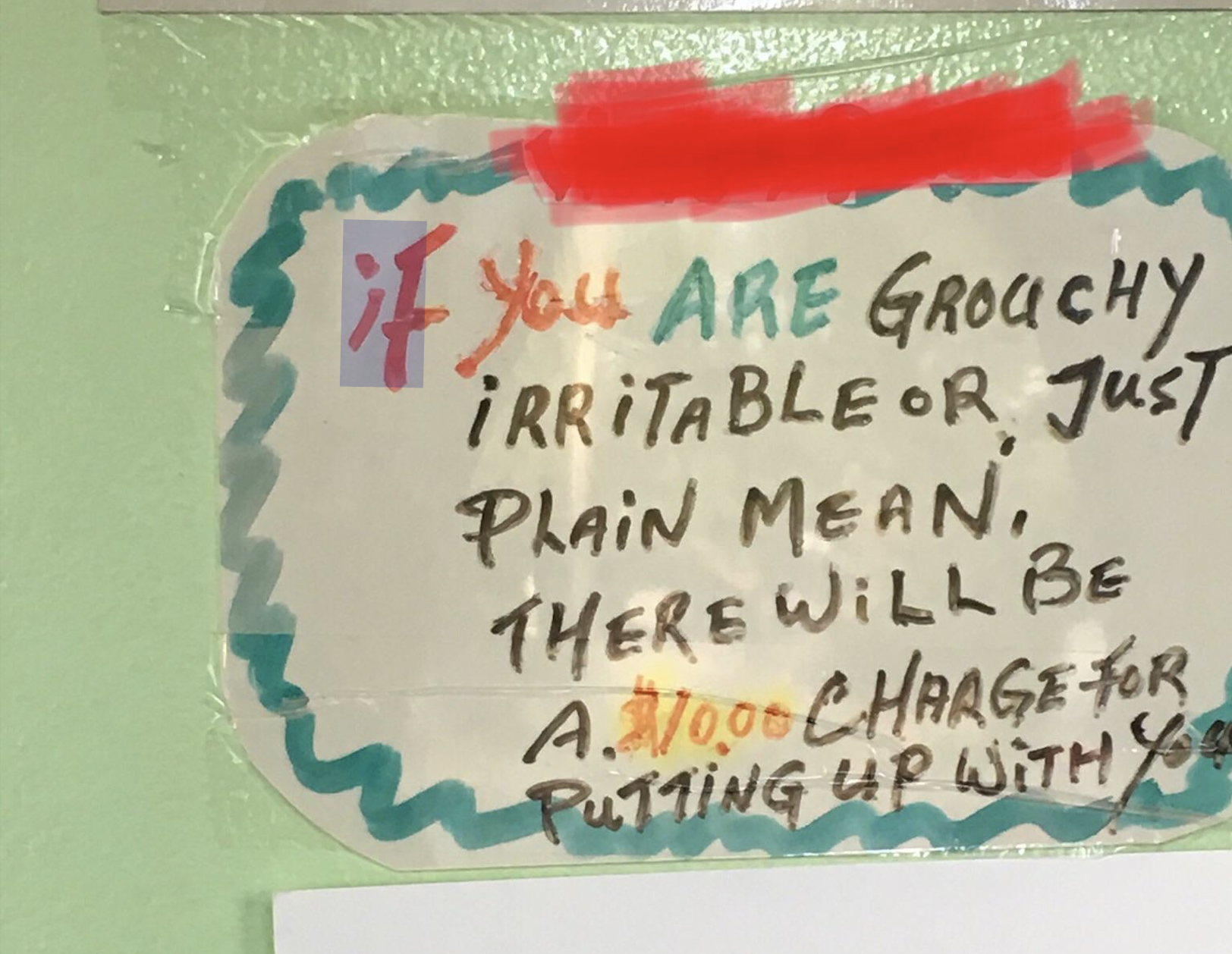 Handwritten sign reading, “If you are grouchy, irritable or just plain mean, there will be a charge for putting up with you.”