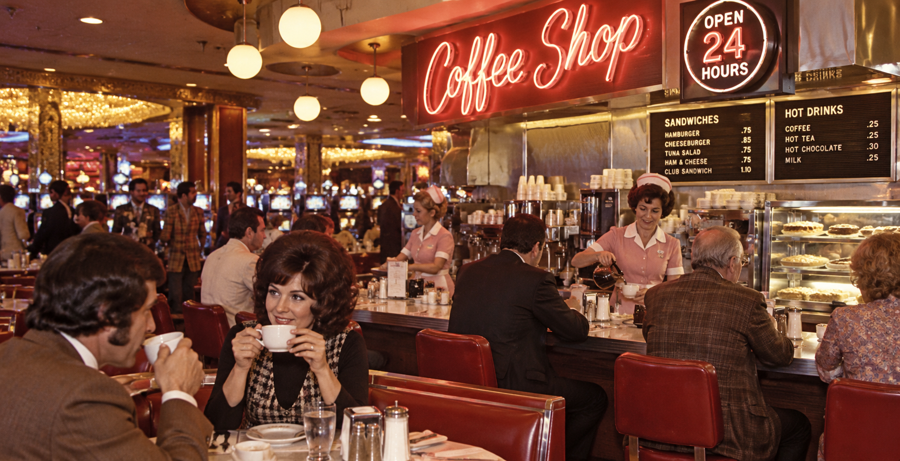 A retro diner with red booths, neon “Coffee Shop” sign, and waitresses in pink uniforms serving customers—true to Old Las Vegas Traditions. People are drinking coffee and talking at the counter.