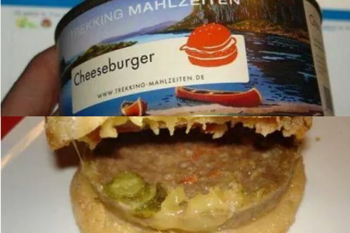 A can of Trekking Mahlzeiten cheeseburger meal next to a prepared cheeseburger on a white plate.
