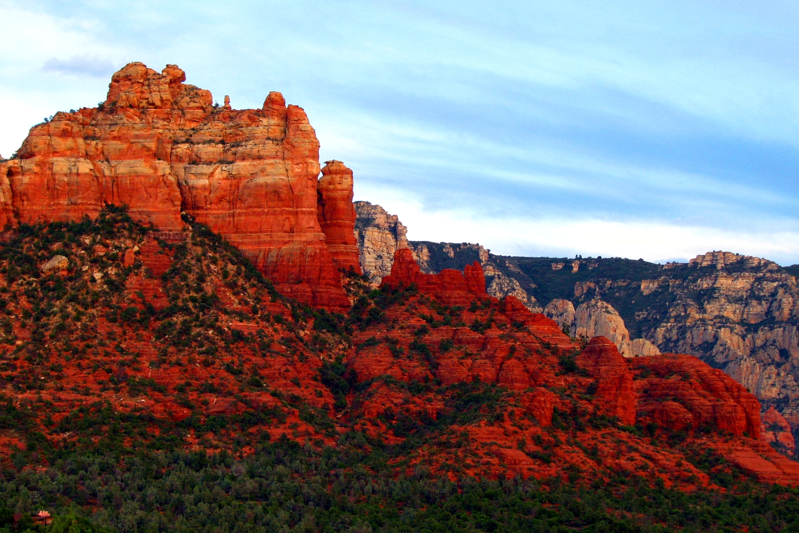 Red rock mesas and cliffs under a blue sky.