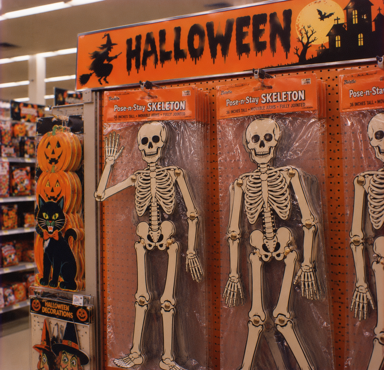 Halloween display in a store featuring packages of 36-inch poseable skeleton decorations.