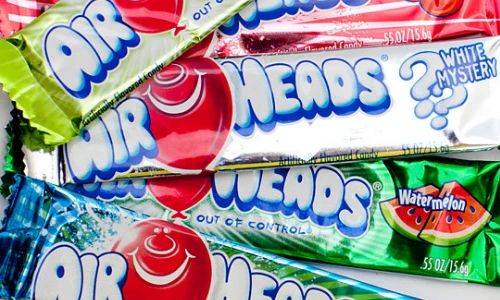 Stacked AirHeads candy bars in White Mystery and Watermelon flavors.