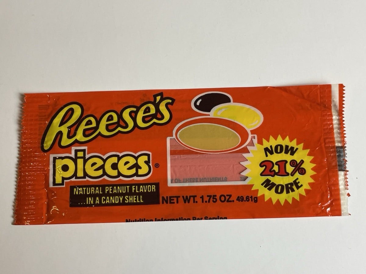 Reese’s Pieces candy package with a yellow starburst label stating “Now 21% More.”