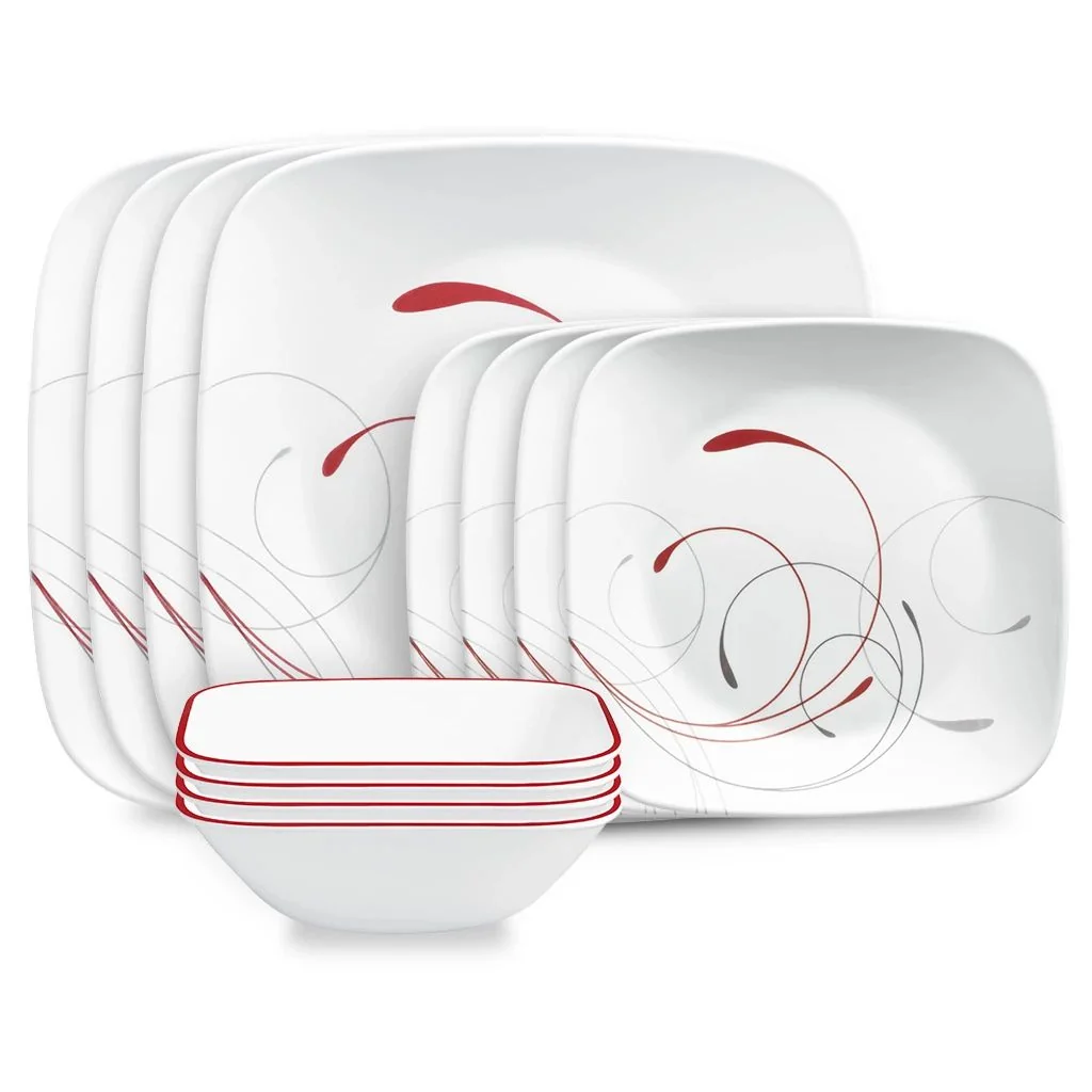 A set of square white dinner plates with red and gray swirl patterns, stacked next to a stack of square white bowls with red rim accents.