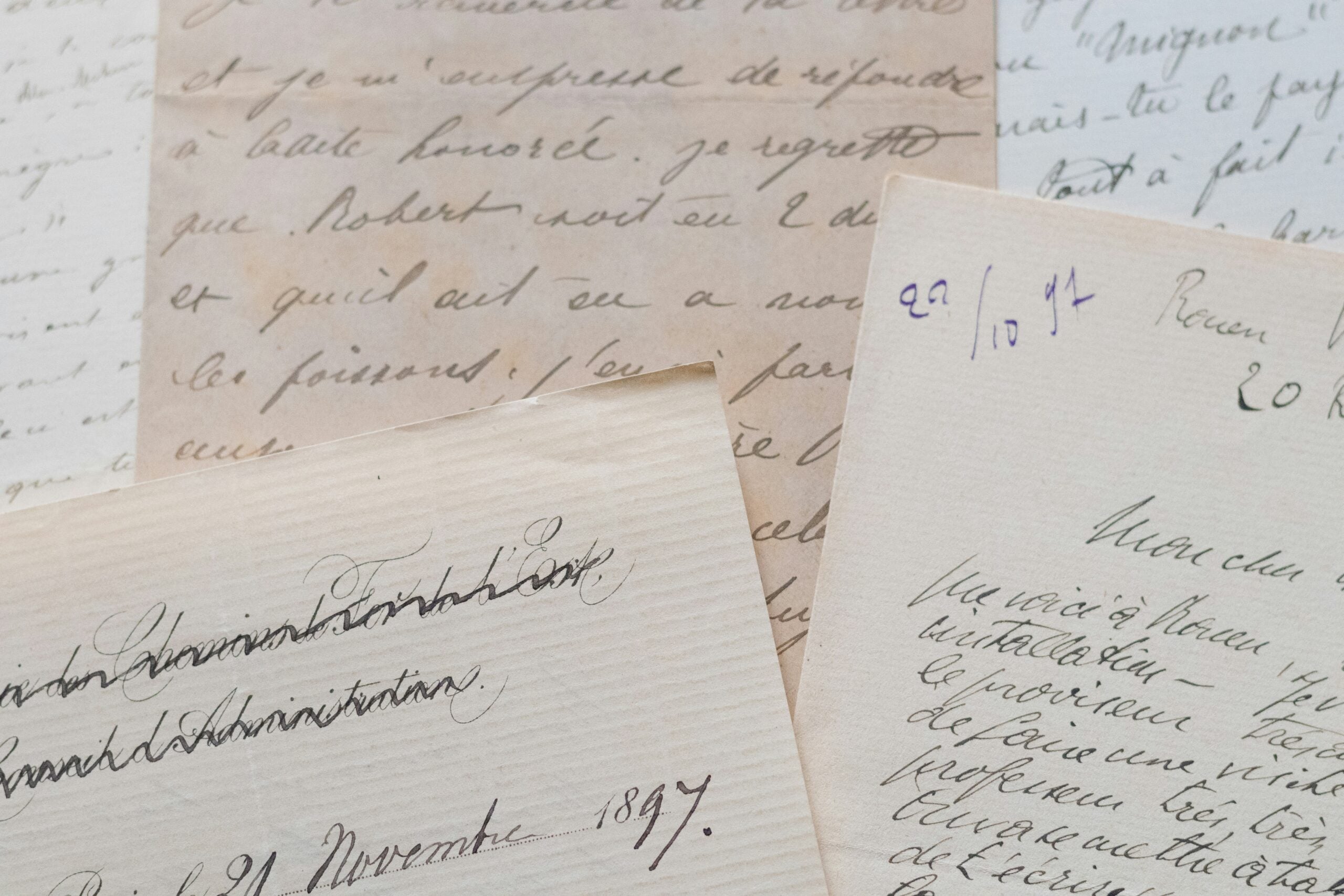 Several overlapping pages of vintage handwritten letters in French with cursive ink script.