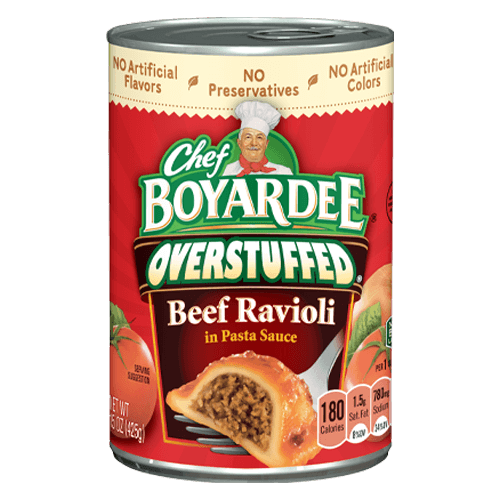 A can of Chef Boyardee Overstuffed Beef Ravioli in Pasta Sauce, featuring a ravioli image and nutritional info on the label. The can advertises no artificial flavors, preservatives, or colors.