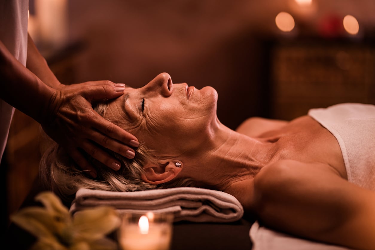 A person receives a relaxing head massage at a spa.