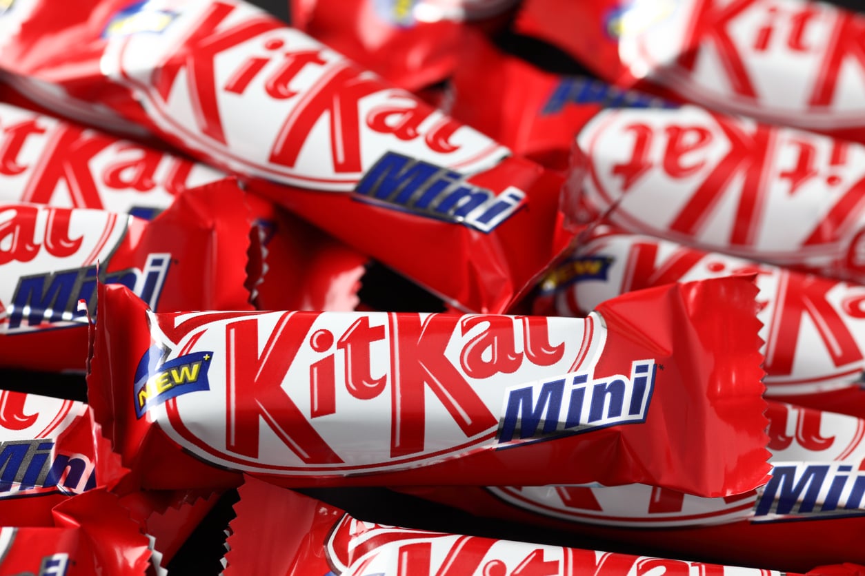 A pile of red-and-white KitKat Mini candy bar wrappers.