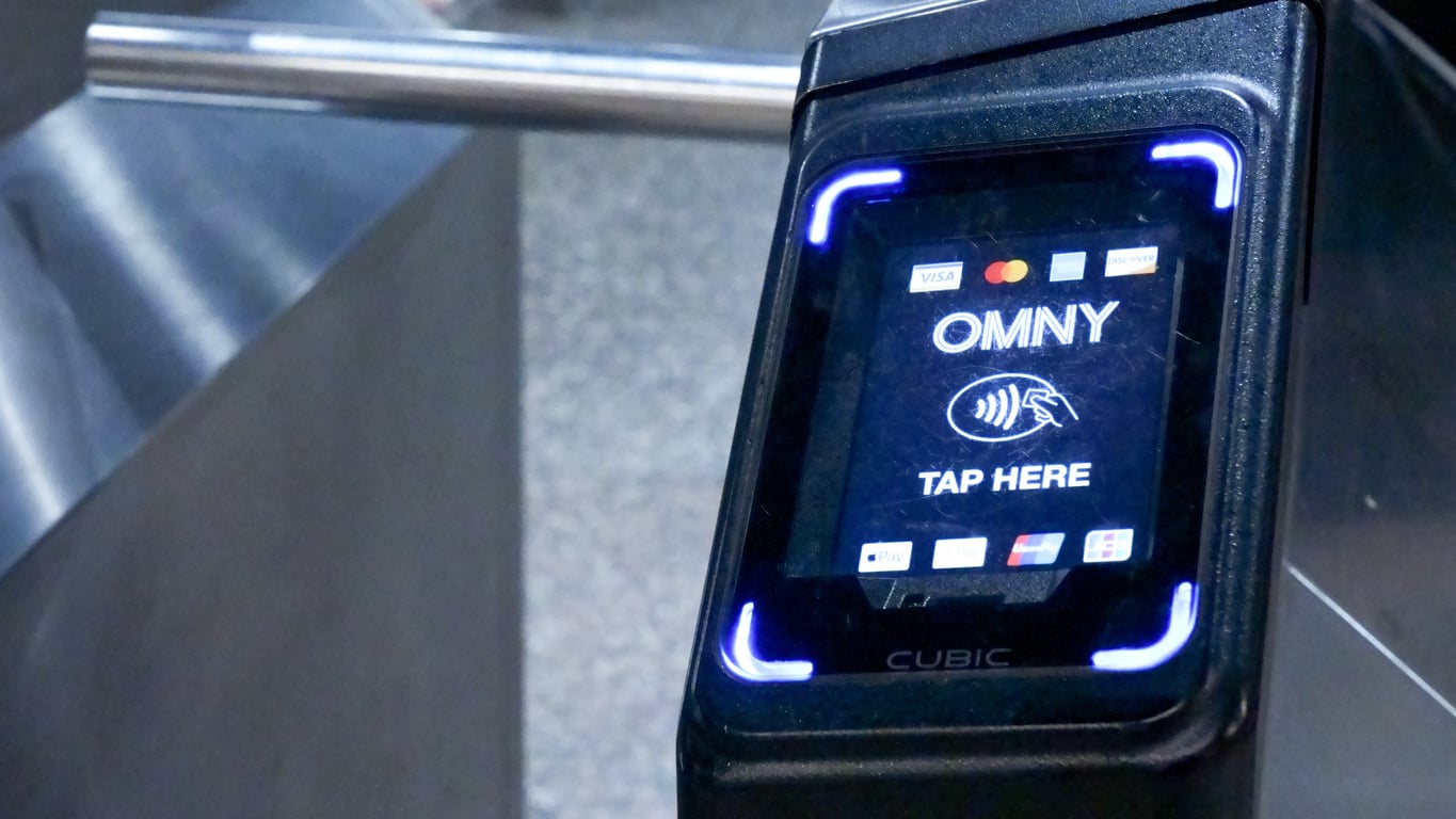 OMNY contactless payment reader on a subway turnstile.