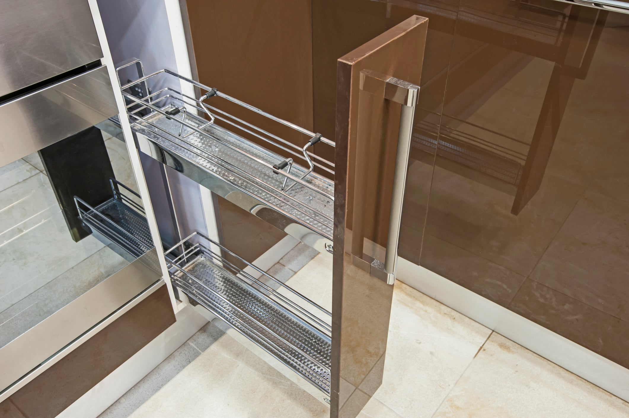 A pull-out kitchen pantry cabinet with two chrome wire shelves, perfect for home improvements.