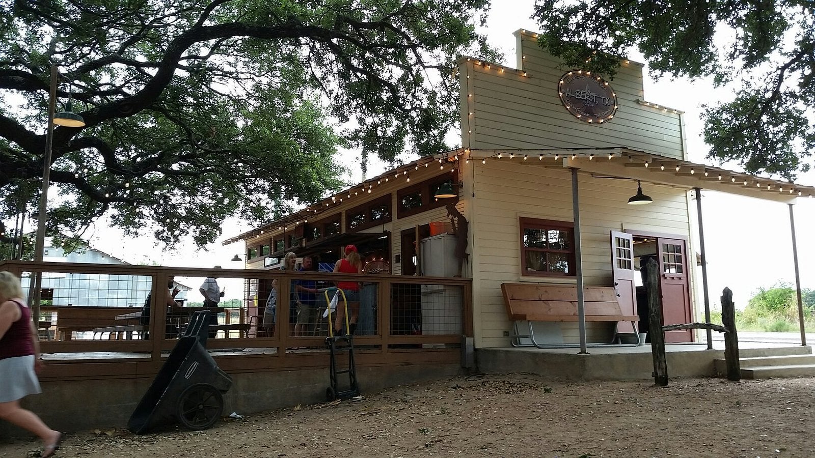 The Albert Dance Hall building with a covered outdoor patio and people gathered at a bar.