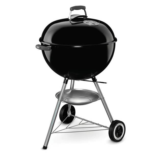 Black kettle-style charcoal grill with a lid, standing on three metal legs with two wheels.