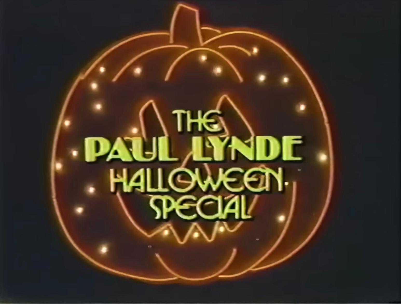 The title card for The Paul Lynde Halloween Special, featuring the show’s name written in yellow letters inside an orange neon pumpkin outline.