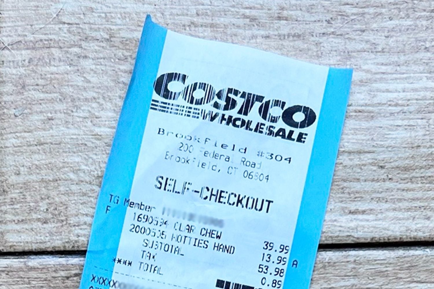 A Costco receipt from the Brookfield, CT location showing a self-checkout transaction with items for 39.99 and 13.99, totaling 53.98 plus tax.