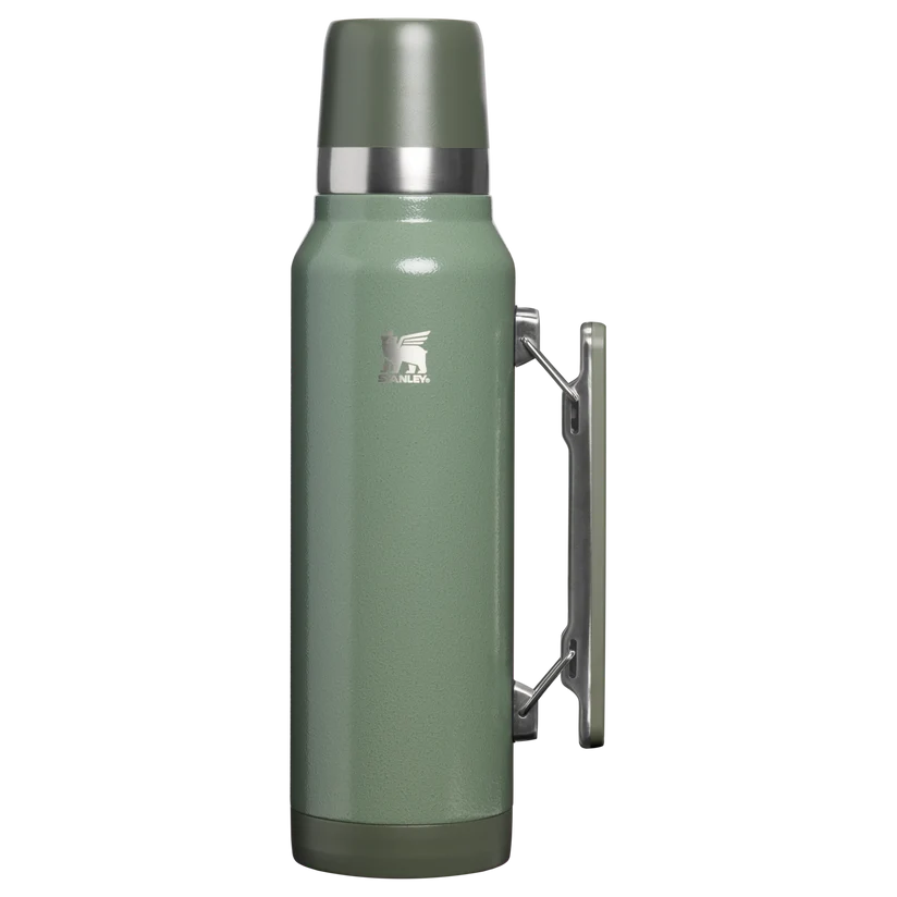 Green Stanley vacuum-insulated thermos with a side handle and a cup lid.
