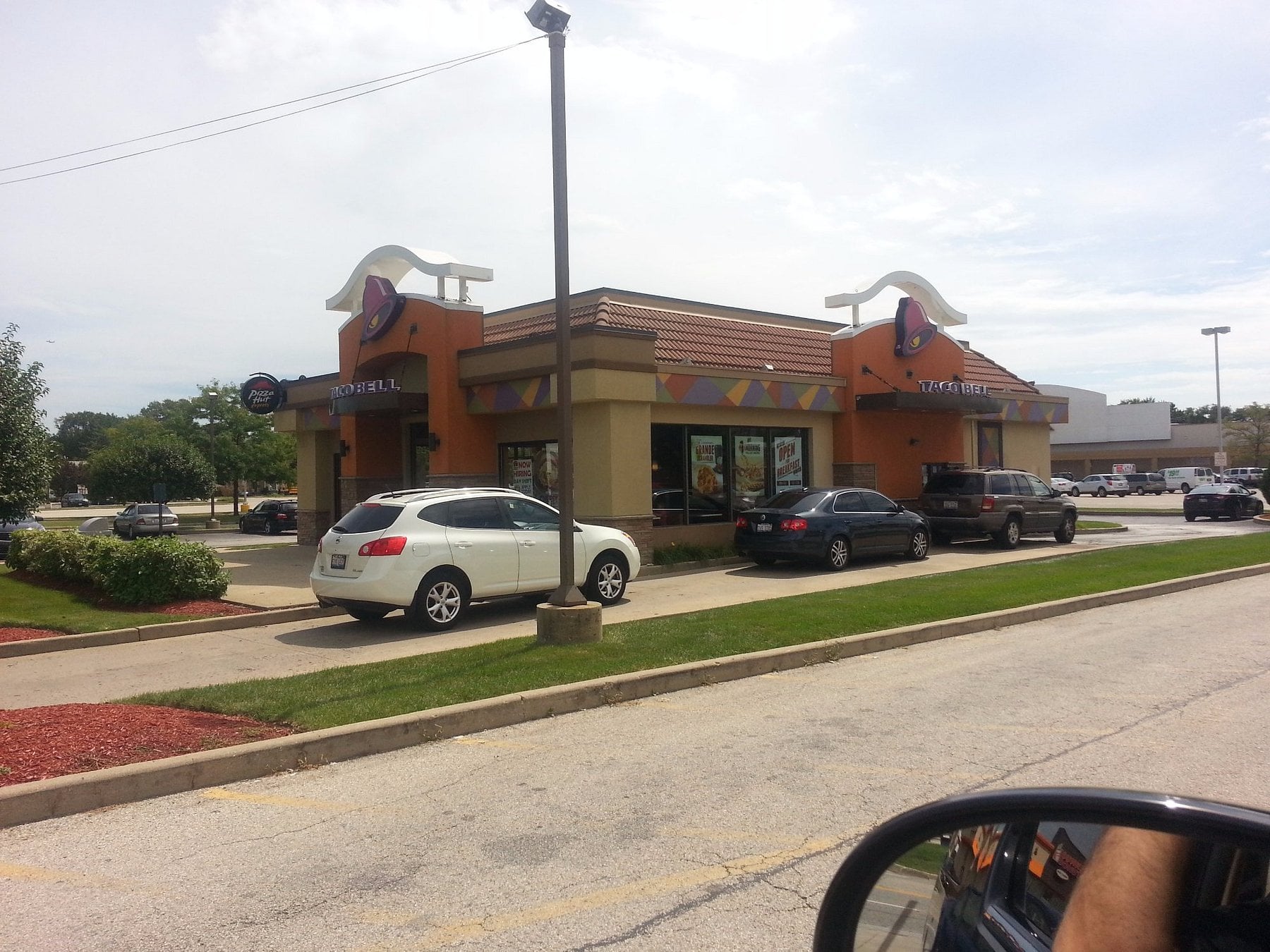 Cars lined up at a Taco Bell drive-thru.