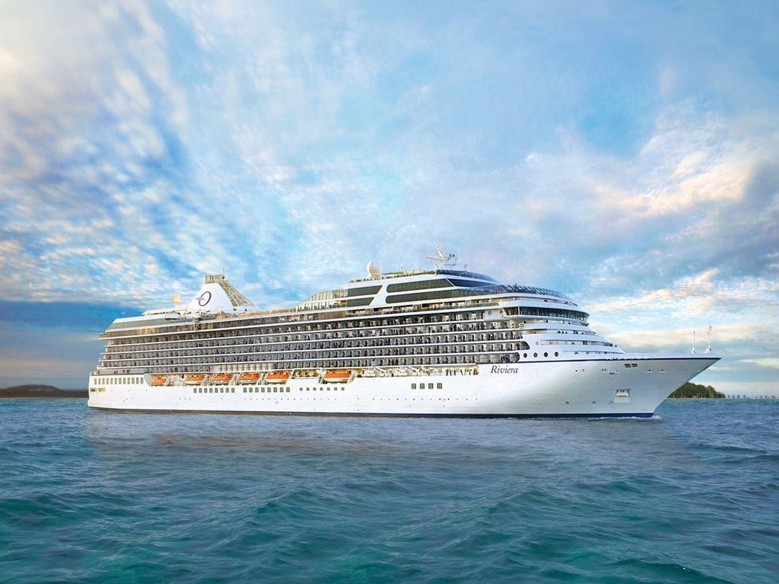 The cruise ship Riviera, known for its expansive cruise ship buffets, sails on the ocean under a blue sky.